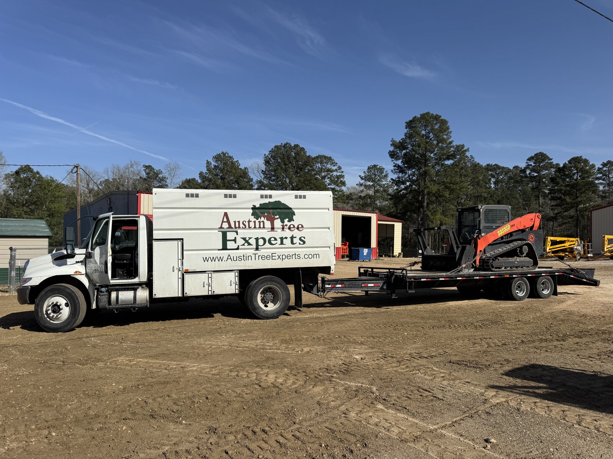 Tree Services 10 Austin Tree Experts truck with tracked mulching skid steer for fuel break work